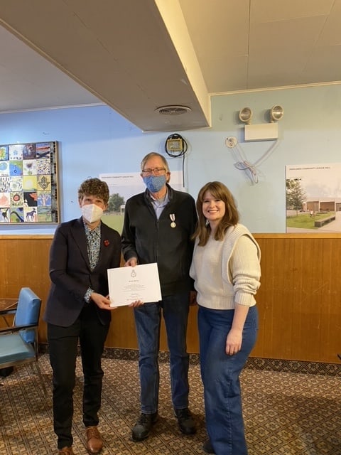 Photo of Janis Irwin (left) presenting the award to Robert McCoy (middle), with Leanne Stroh (right).