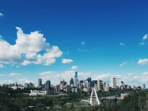 city skyline under blue and white sunny cloudy sky during daytime